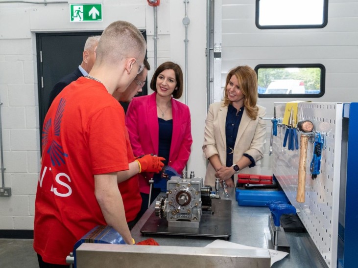 A WTS leaner showing the equipment in the workshop to Education Secretary