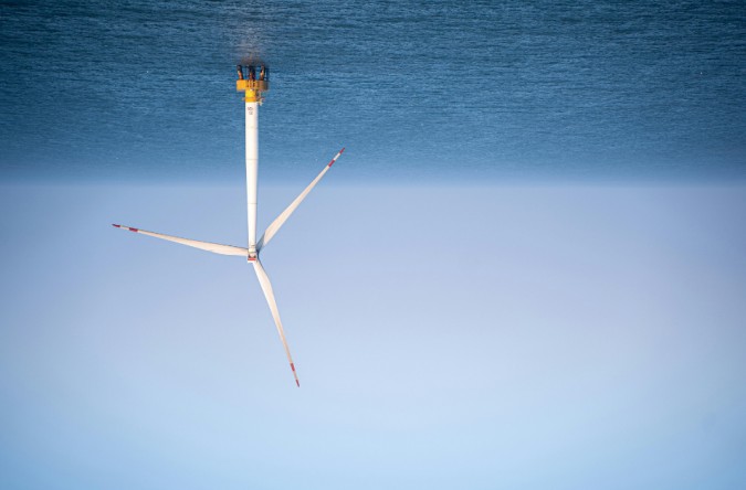 An upside-down wind turbine floating in the ocean on an offshore wind farm.