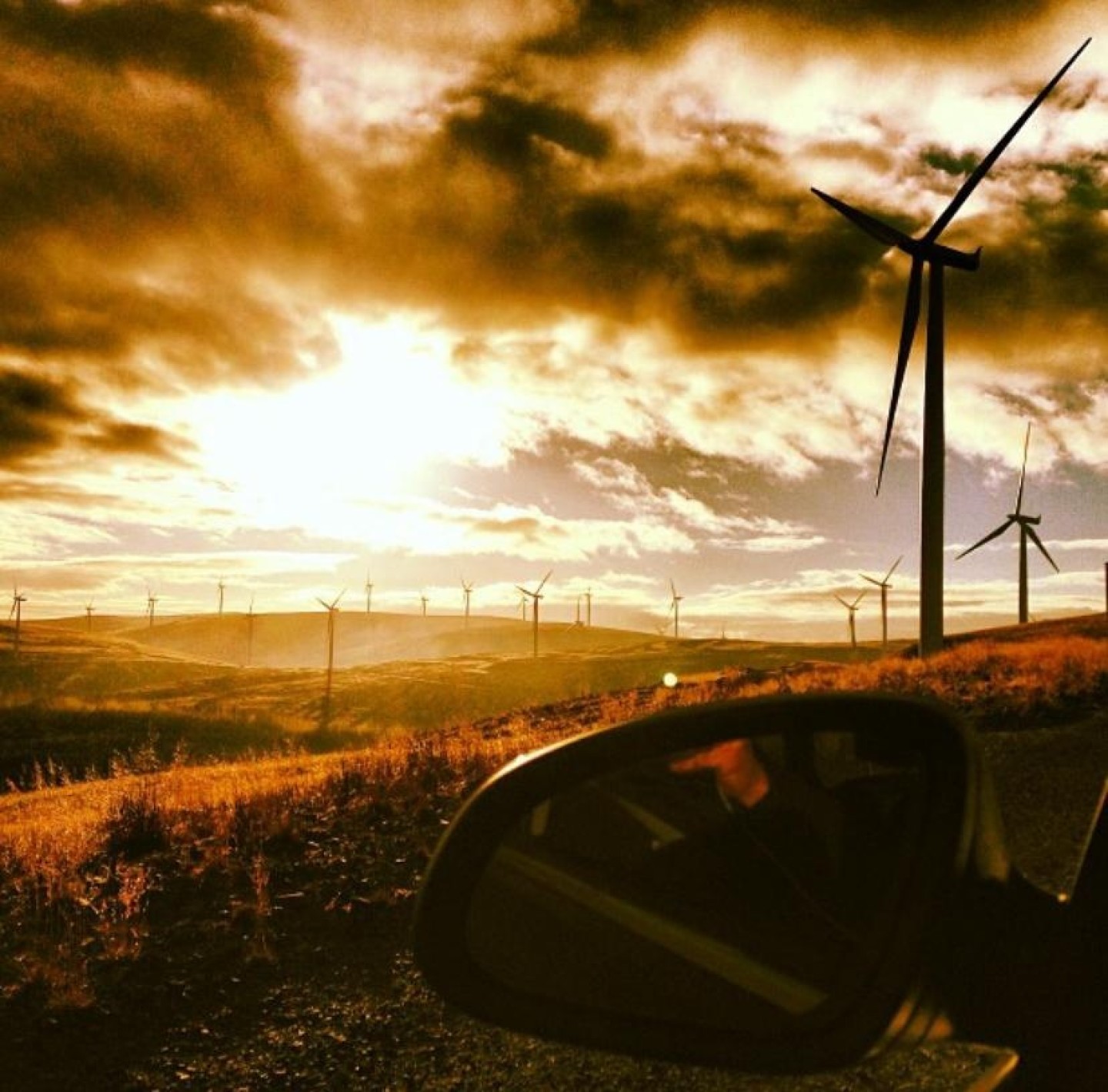 A wind farm in Scotland on a sunny day. Sepia colouring.